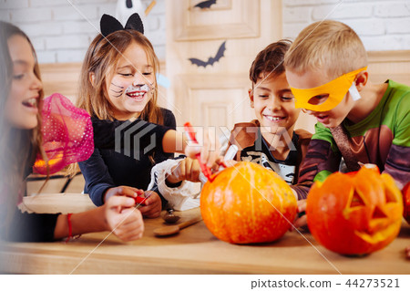 Cute appealing little girl wearing cat costume laughing playing with friends 44273521