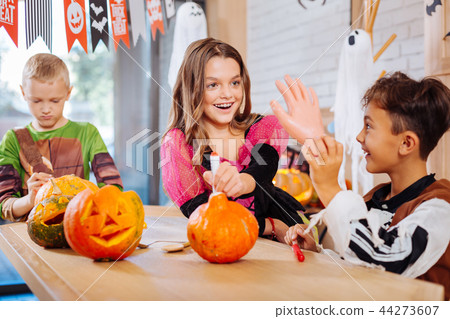 Three children feeling funny while holding scary Halloween toys for the party 44273607