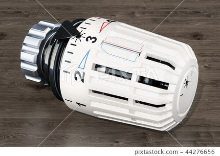 Thermostatic radiator valve on the wooden table Thermostatic radiator valve on the wooden table 44276656