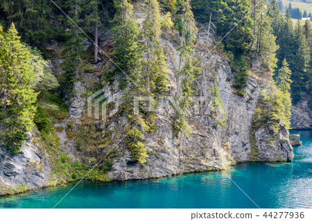 Cliff and blue turquoise water on Saint Gerin lake Cliff and blue turquoise water on Saint Gerin lake 44277936