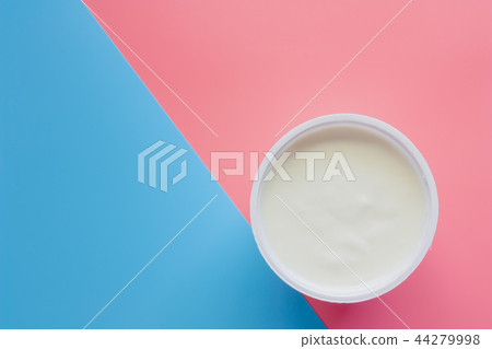 Yogurt on pink and blue pastel background 44279998