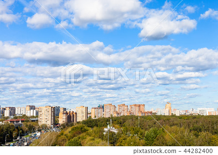 white clouds in blue sky over street and park white clouds in blue sky over street and park 44282400