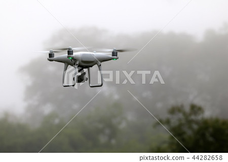 Drone flying in the sky while the rain forests Drone flying in the sky while the rain forests 44282658