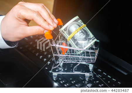 dollars in the supermarket trolley on the keyboard 44283487