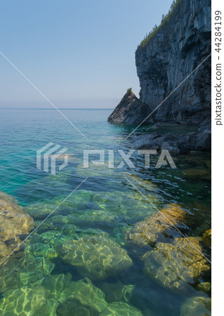 Bright clear aqua green water on Bruce Peninsula with big limest 44284199