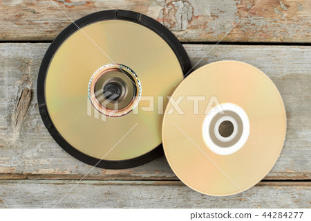 DVD discs on old wooden background. 44284277