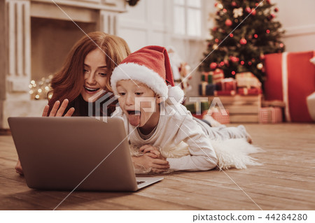 Emotional family watching funny videos on the laptop Emotional family watching funny videos on the laptop 44284280