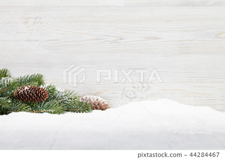Christmas fir tree branch on wooden background Christmas fir tree branch on wooden background 44284467