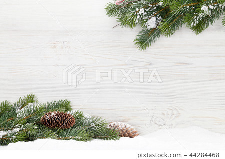Christmas fir tree branch on wooden background Christmas fir tree branch on wooden background 44284468