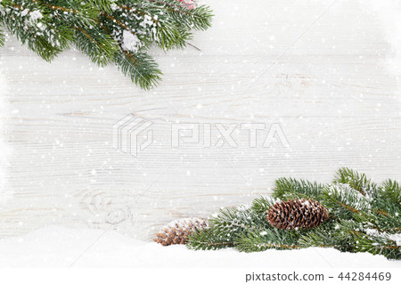 Christmas fir tree branch on wooden background Christmas fir tree branch on wooden background 44284469
