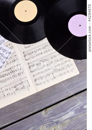 Vinyl records and musical notes sheets. 44284878