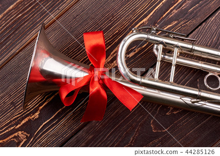 Trumpet with red bow. Trumpet with red bow. 44285126