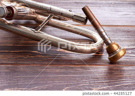 Vintage trumpet on wooden background. Vintage trumpet on wooden background. 44285127