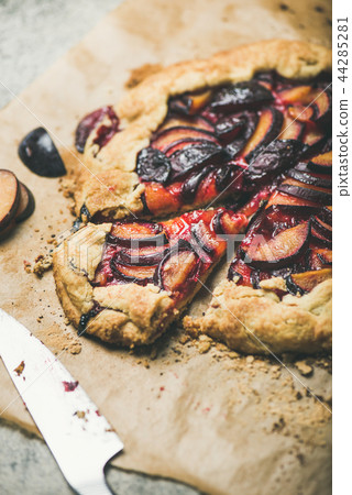 Plum galetta sweet cake dessert on baking paper, selective focus 44285281