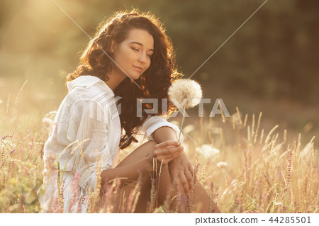 Beautiful carefree woman in fields being happy outdoors 44285501