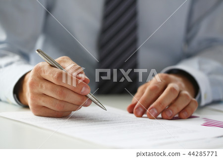 Hand of businessman in suit filling and signing with Hand of businessman in suit filling and signing with 44285771