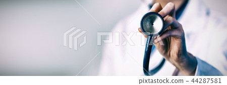 Doctor holding stethoscope Doctor holding stethoscope 44287581