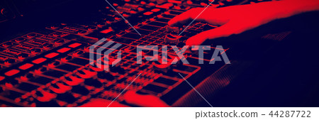 Cropped hands of audio engineer using sound mixer 44287722