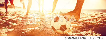 Friends playing football 44287912