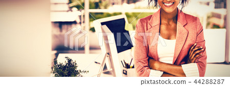 Casual female artist with arms crossed at bright office Casual female artist with arms crossed at bright office 44288287
