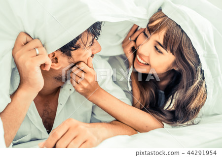 Happy young couple relaxing in the home bedroom. 44291954