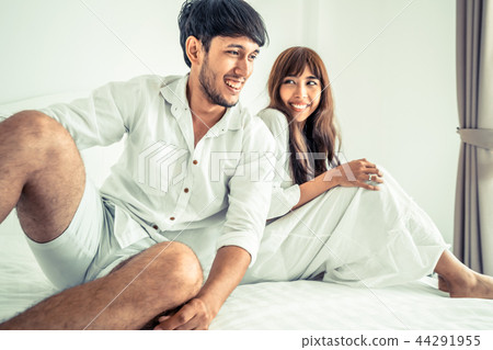 Happy young couple relaxing in the home bedroom. 44291955