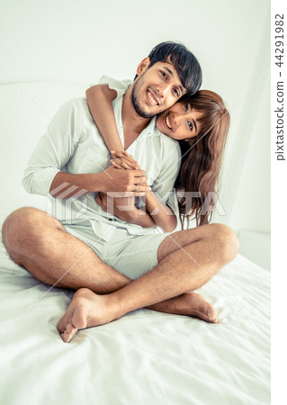 Happy young couple relaxing in the home bedroom. Happy young couple relaxing in the home bedroom. 44291982