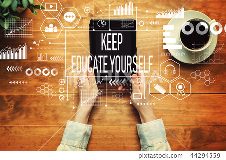 Keep educate yourself with a person holding a tablet 44294559