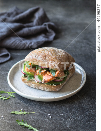 Sandwich with roasted salmon, arugula, avocado, Sandwich with roasted salmon, arugula, avocado, 44296277