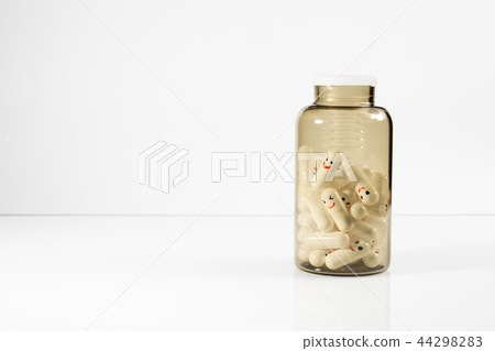 Glass bottle with fun painted emotions on the capsules. 44298283