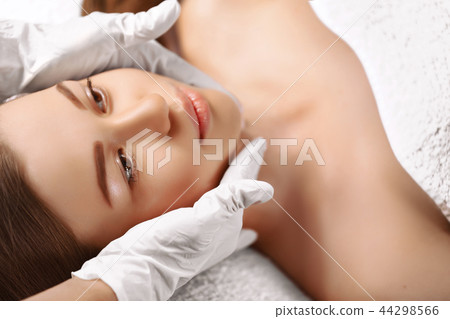 Portrait of fresh and beautiful brunette woman taking head massa 44298566