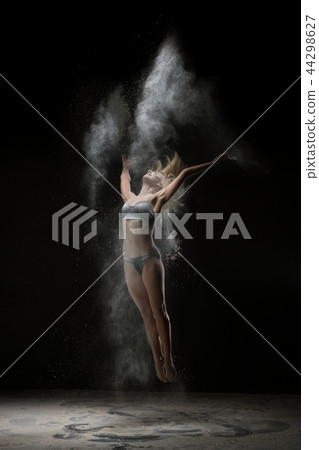 Young girl in lingerie in white dust cloud Young girl in lingerie in white dust cloud 44298627