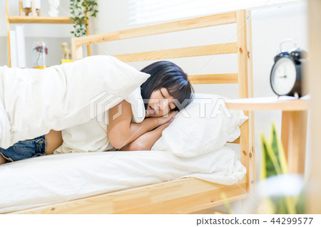 Asian Taiwanese Chinese women sleeping warm alarm clock getting out of bed 44299577