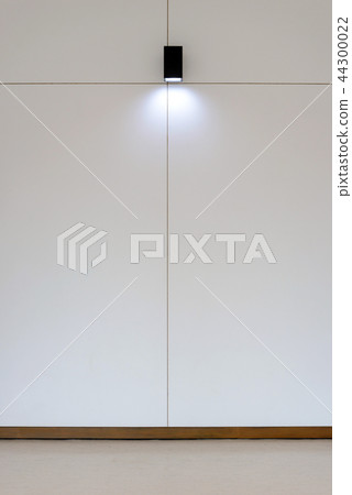 Model lamp on wooden wall in room 44300022