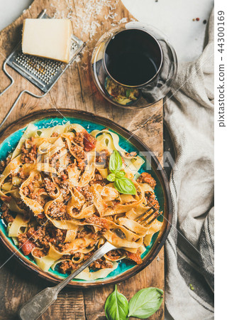 Pasta dinner with tagliatelle bolognese and red wine, top view Pasta dinner with tagliatelle bolognese and red wine, top view 44300169