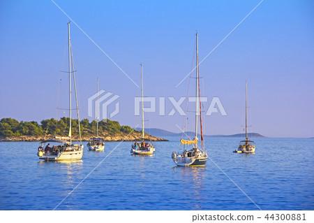 Anchored sailing boats in the bay on island Murter Anchored sailing boats in the bay on island Murter 44300881