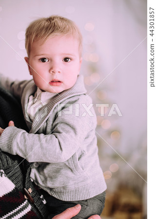 Cheerful little baby boy playing near Christmas tree Cheerful little baby boy playing near Christmas tree 44301857
