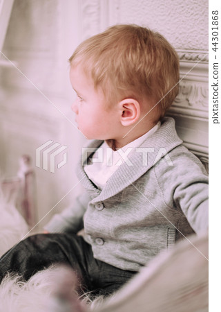 Cheerful little baby boy playing near Christmas tree 44301868