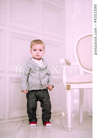 Cheerful little baby boy playing near Christmas tree 44301899