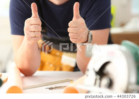 Arm of worker show confirm sign with thumb up 44303726