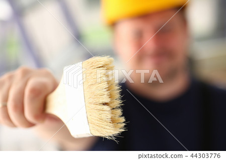 Arm of smiling worker hold brush closeup 44303776