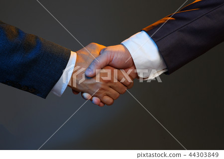 Man in suit shake hand as hello in office closeup 44303849