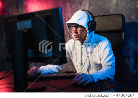 Professional Boy Gamer Plays in Video Game on a eSports Tournament or in Internet Cafe. He Wears 44304264