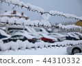 barbed wire fence on winter time backgruond white snow 44310332