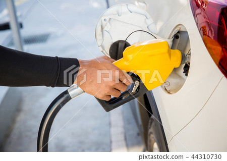 Man Refill and filling Oil Gas Fuel at station. Man Refill and filling Oil Gas Fuel at station. 44310730