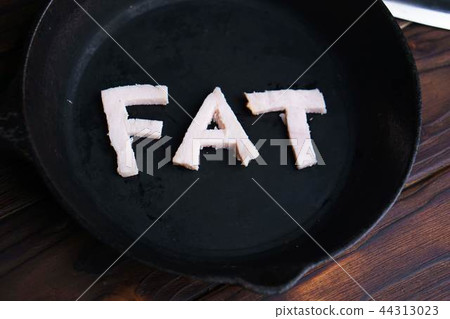 Frying pan with word Fat carved of bacon 44313023