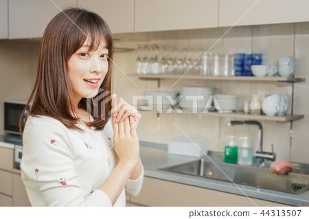 在膳食以後的年輕日本婦女洗滌的盤 在膳食以後的年輕日本婦女洗滌的盤 44313507