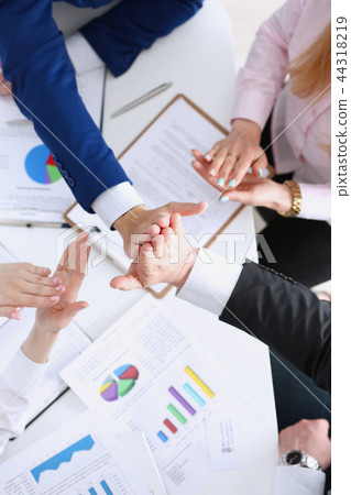 Group of people in suits crossed hands Group of people in suits crossed hands 44318219