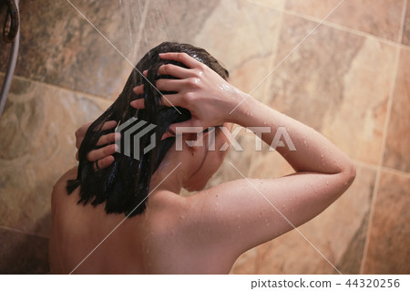 Beautiful young woman using shampoo taking bath. Beautiful young woman using shampoo taking bath. 44320256