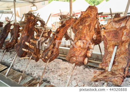 Roasted meat of beef cooking. Asado Argentina Roasted meat of beef cooking. Asado Argentina 44320888